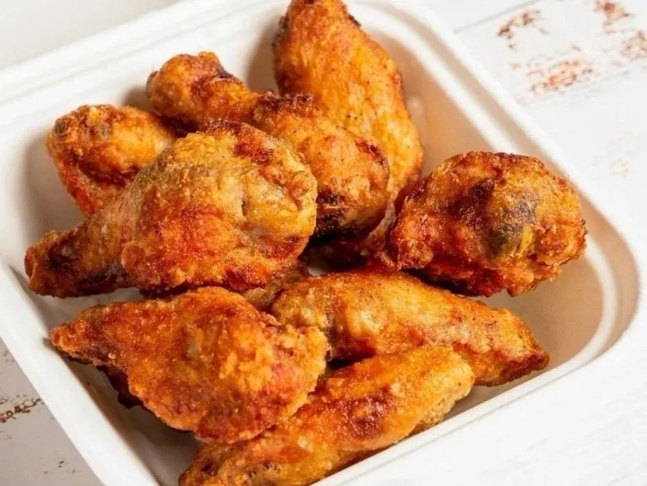 One pound of chicken wings, sauced and tossed to order